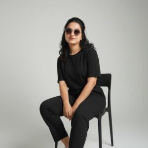Black women dress worn by model sitting on chair